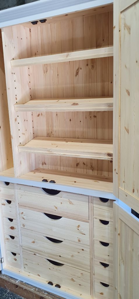 Art cupboard sloping shelves